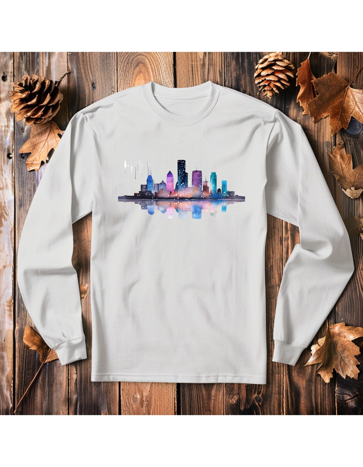 White long sleeve t-shirt with the graphic of the skyline of downtown Houston. The graphic is painted in water color style.
