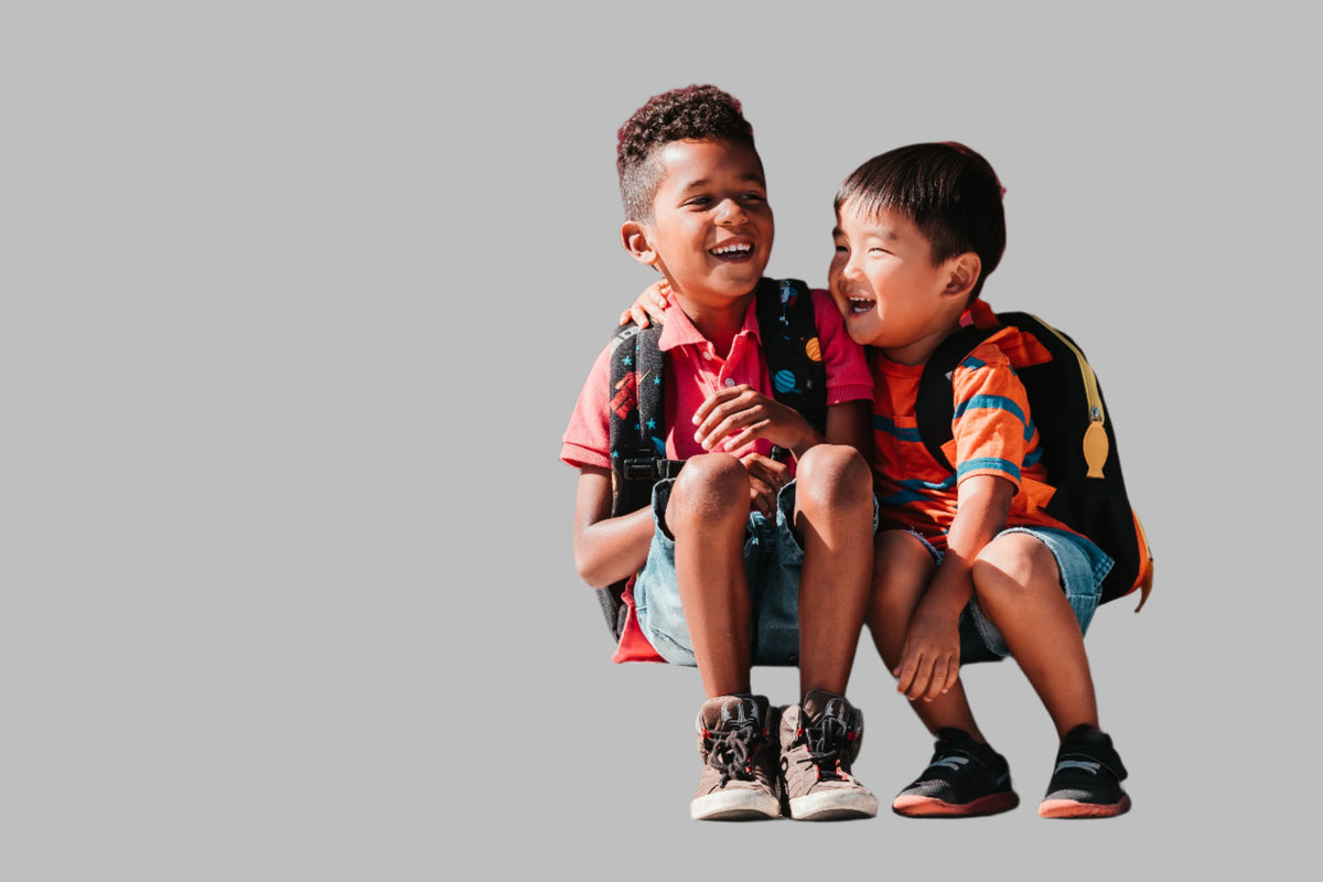 Children sitting down and laughing together.